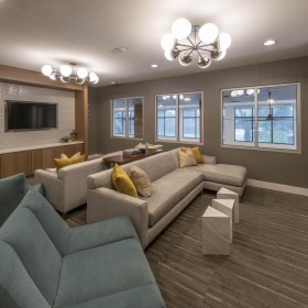 Access to resident-only features clubroom with wall mounted tvs and couches