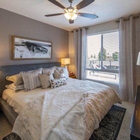 Relax and recharge in beautiful and spacious bedrooms spacious bedroom with ceiling fan and light fixture