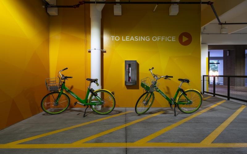 a couple of bikes parked in a parking garage